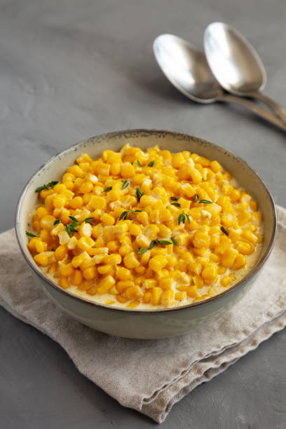 istock Homemade Slow Cooker Creamed Corn in a Bowl on a gray background, low angle view. 2154689503