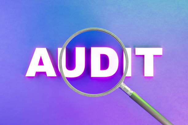 istock Audit with magnifying glass on neon lighting background 2154690084