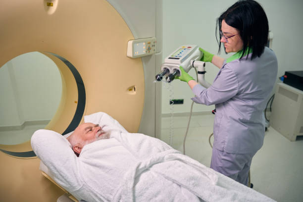 istock Patient watches a doctor setting up an MRI machine 2154690404