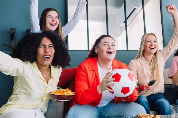 istock Soccer's female match cheering on TV 2154690749