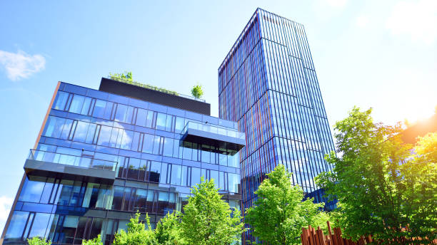 istock Sustainable glass office building with trees for reducing carbon dioxide. 2154691593