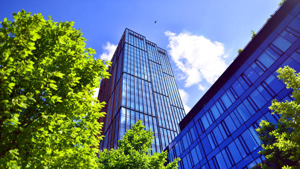 istock Sustainable glass office building with trees for reducing carbon dioxide. 2154691635