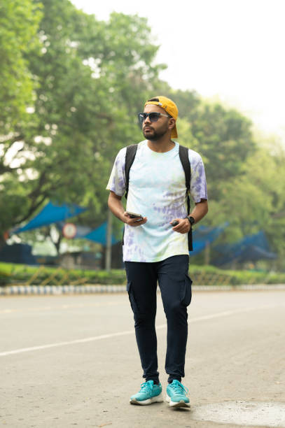 istock Young Man Walking with Smartphone in Casual Outfit 2154695050
