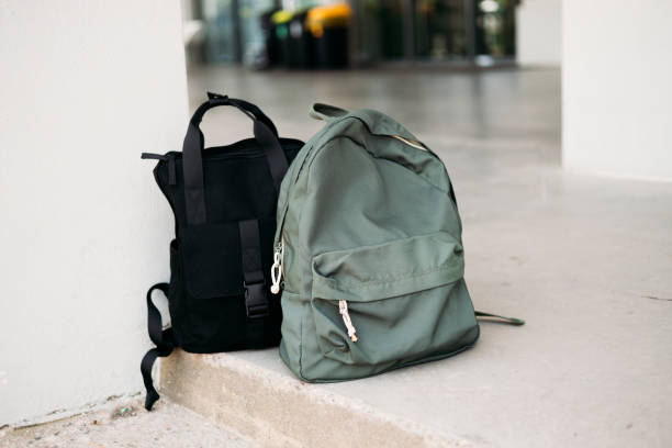 istock A lost or forgotten backpacks on a floor on an open platform. Forgotten luggage. Lost hand luggage. The concept of travel. 2154696962