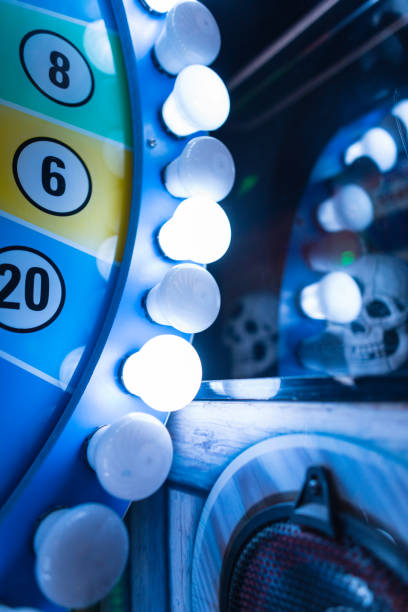 istock Retro fortune wheel with light bulbs on blue background in the park 2154697490