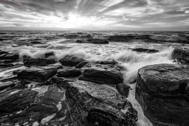 istock rocky sea coast in black and white. 2154699086