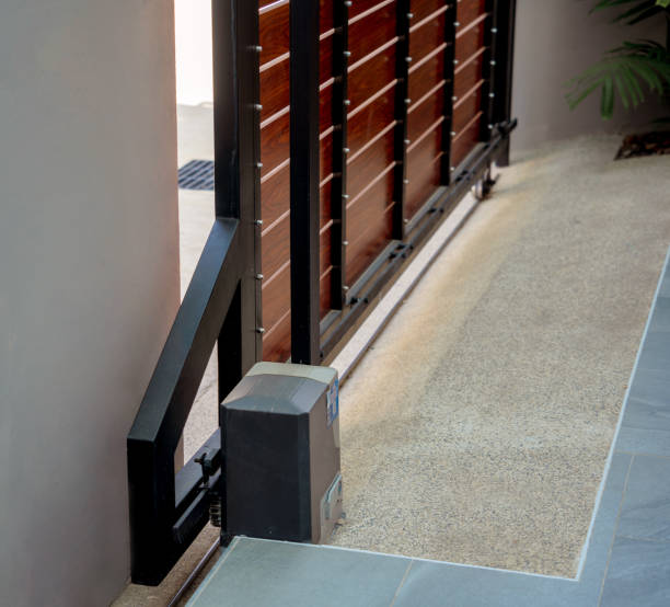 Automatic sliding front gate at modern villa Automatic sliding front gate at modern villa. automatic garage door stock pictures, royalty-free photos & images