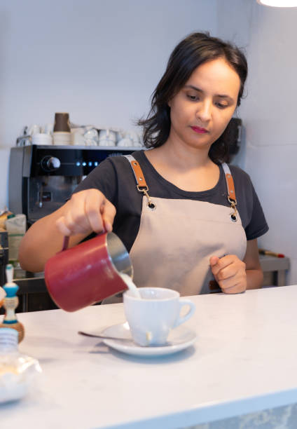 istock Moroccan woman waitress serving a latte in a cafe 2154699712