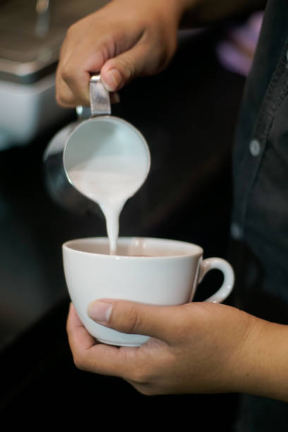 istock Barista making frothy art on latte 2154699758