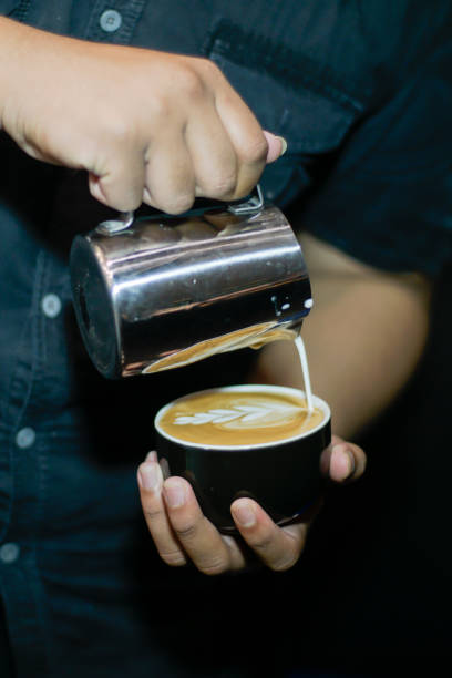 istock Barista making frothy art on latte 2154699990