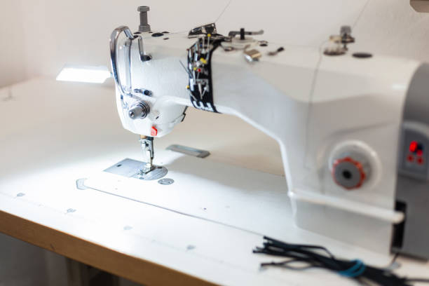 istock White sewing machine in the working room. Creative work with the creation of clothing 2154700148