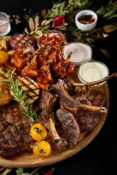 istock Delicious Outdoor BBQ Feast with Assorted Grilled Meats and Vegetables 2154700404