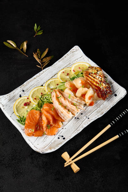 istock Diverse Sashimi Platter With Salmon, Shrimp, Scallop, Eel on Elegant Tableware 2154701826