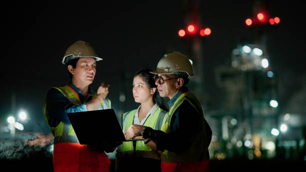 istock Business people, architect and tablet in construction planning, meeting or collaboration on site at night. 2154702059
