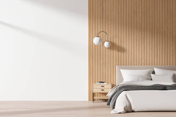 istock Modern bedroom interior with wooden wall design, cozy bed with pillows, and a bedside table in a bright space, concept of minimalism. 3D Rendering 2154702620