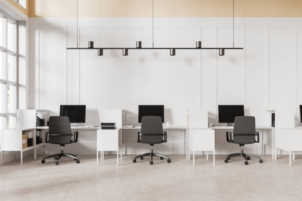 istock Modern office coworking interior with pc monitors and armchairs in row, window 2154702756