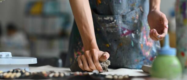 istock Banner cover with Young Artist's hands pressing and kneading clay in a workshop, Panorama image 2154703156