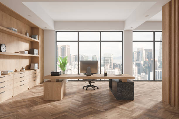 istock Wooden business interior with work desk, pc desktop and shelf near window 2154703342