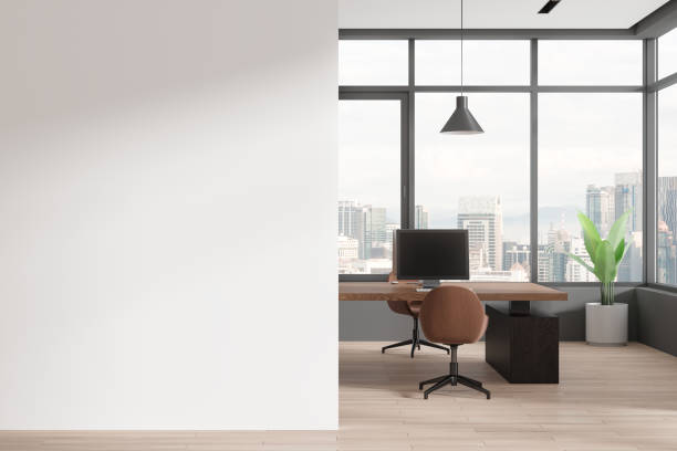 istock Cozy coworking interior with pc computers on a shared desk, window. Mock up wall 2154703468