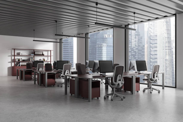 istock Gray and red hot desk office corner with row of computer desks 2154703836