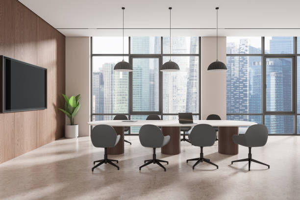 istock A modern office interior with a conference table, chairs, a plant, and a TV against a backdrop of large windows with a city view, 3D Rendering. 2154703891