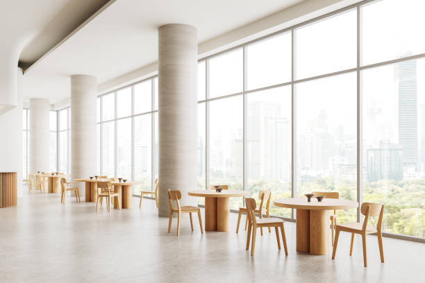 istock Modern cafe interior with wooden tables and chairs by large windows overlooking a cityscape, minimalist design, 3D Rendering. 2154704209