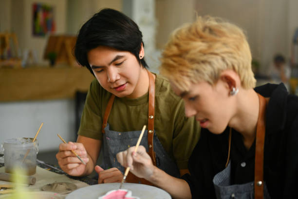 istock Two students focused on painting clay in an art class, Learning activity ideas about art subjects 2154704495