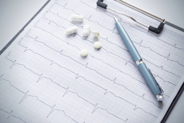 istock stethoscope, tablets and pen lie on the cardiogram. medical concept 2154705337