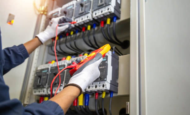 istock Electricity and electrical maintenance service, Engineer hand holding AC voltmeter checking electric current voltage at circuit breaker terminal and cable . 2154707843