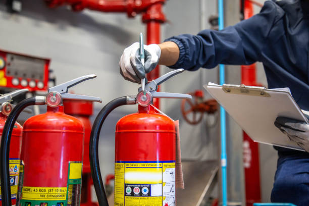 istock Fire extinguisher, Engineer inspection checking pressure gauge level fire extinguisher tank for protection and prevent emergency and safety 2154707844