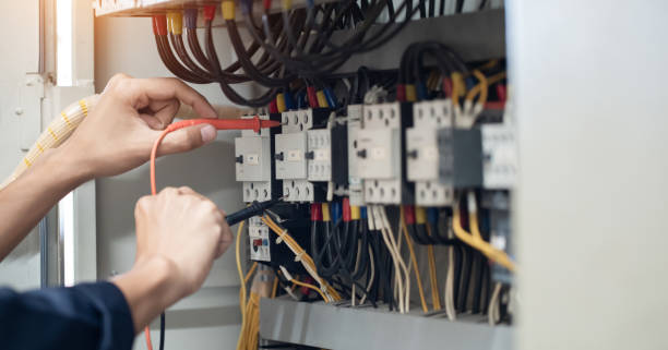 istock Electricity and electrical maintenance service, Engineer hand holding AC voltmeter checking electric current voltage at circuit breaker terminal and cable . 2154707867