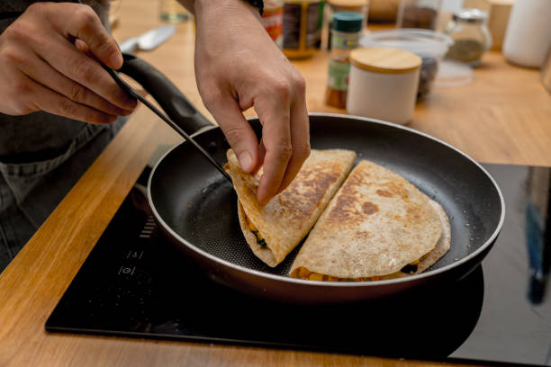 istock Chef at the kitchen preparing quesadillas with tofu and sweet corn 2154708191