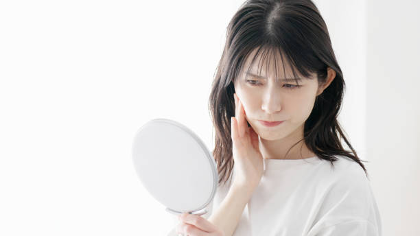 istock A woman concerned about rough skin 2154708686