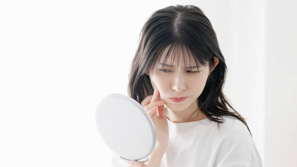 istock A woman concerned about rough skin 2154708693