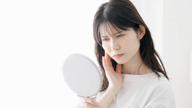 istock A woman concerned about rough skin 2154708716