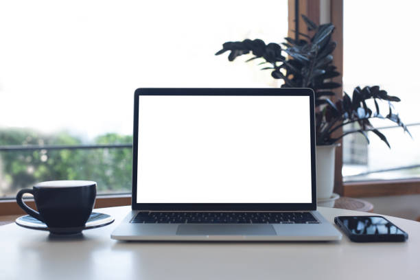 istock Mockup, laptop blank screen on wood table with coffee cafe background, template for your text advertisement, front view 2154710305