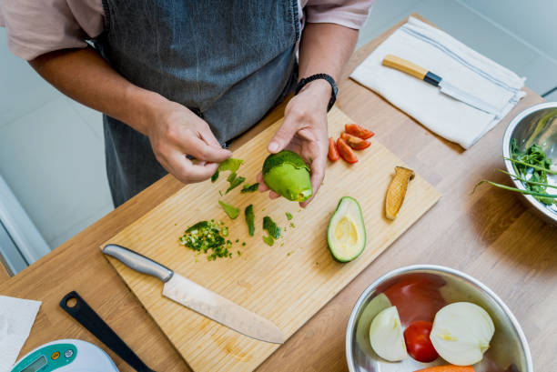 istock Chef at the kitchen preparing healthy quinoa bowl with avocado 2154710910