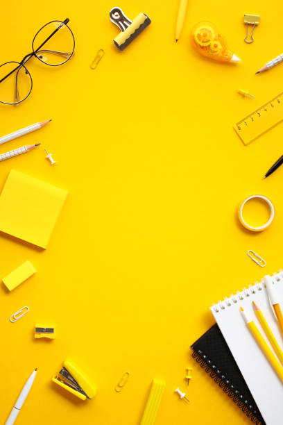 istock Flat lay vertical composition with office supplies on yellow background. Perfect for themes related to education, art, and office aesthetic 2154713361