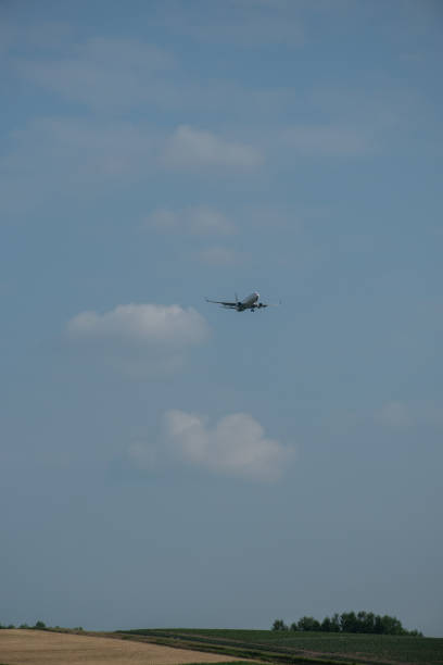 istock Airplane flying over the summer field area 2154715590