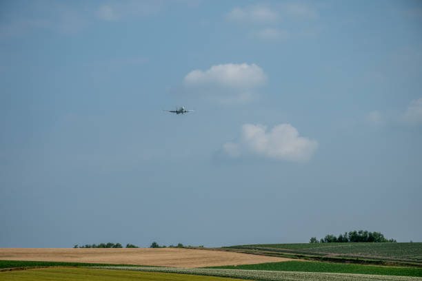 istock Airplane flying over the summer field area 2154715877