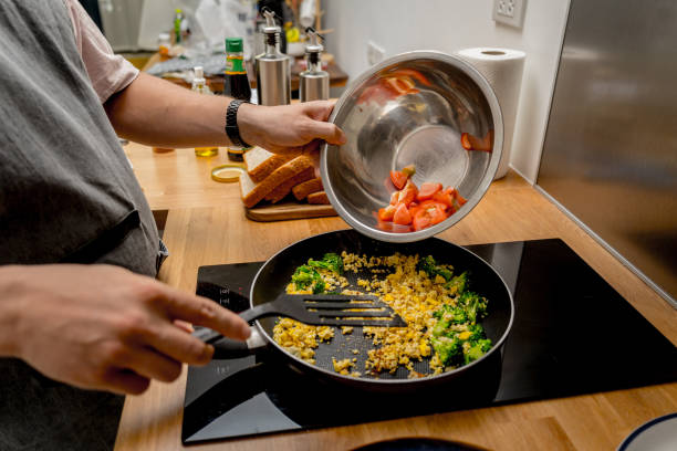 istock Chef at the kitchen preparing tofu scramble with vegetables 2154716096