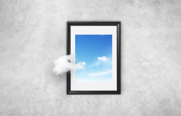 istock Beautiful picture with a black frame with blue sky and cloud on a gray concrete wall. Concept think differently. Going beyond. Think outside the box surreal minimal concept 2154716179