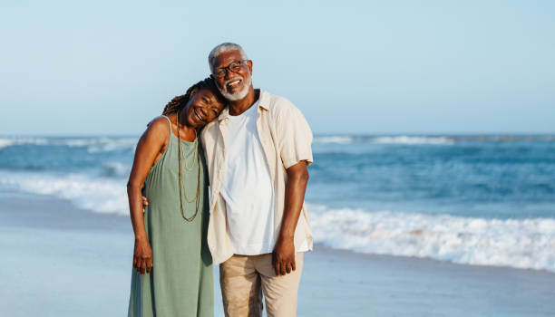 istock Joyful mature African American couple strolling on the beach 2154716779