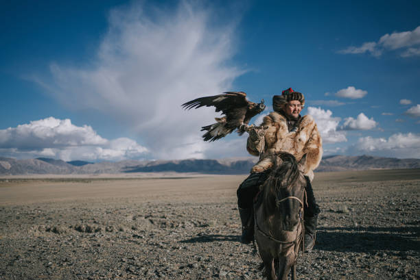 istock proud Kazakh eagle hunters riding horses looking at camera smiling Bayan Olgii, West Mongolia 2154717057