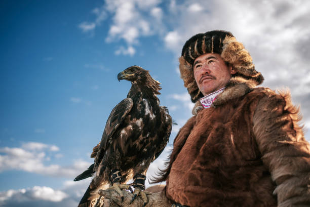 istock proud Kazakh eagle hunters with golden eagle looking at away Bayan Olgii, West Mongolia 2154717634