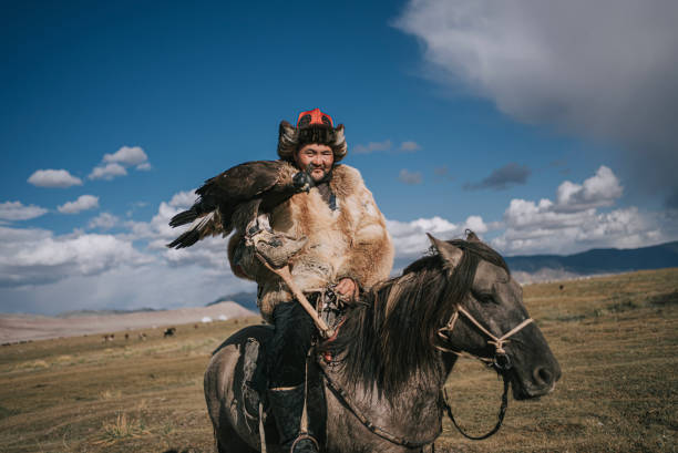 istock proud Kazakh eagle hunters riding horses looking at camera smiling Bayan Olgii, West Mongolia 2154717653