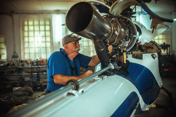 istock Senior mechanic working on helicopter in hangar 2154718019