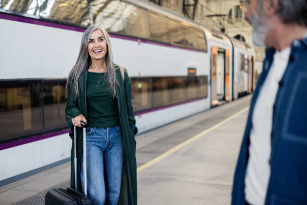 istock Senior woman and her husband going on a journey by a train 2154718722