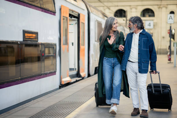 istock Happy mature couple going on a journey by the train 2154718743