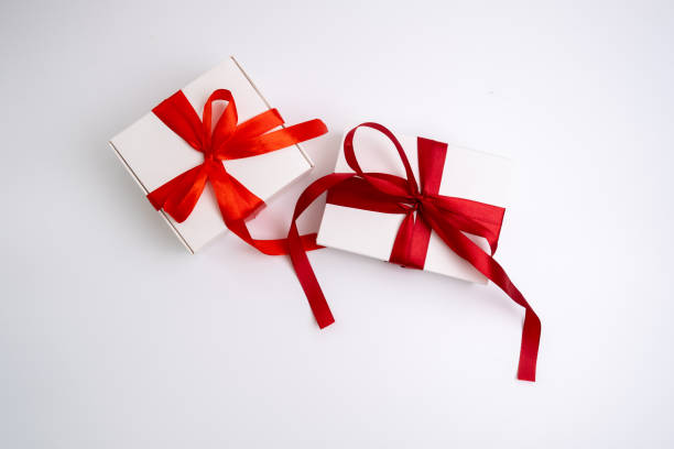 istock Gift box with a bow on a colored background. Happy Holidays, gift box close-up. Boxing Day surprise. Magic time. Wrapping paper, toys and ribbon 2154722091